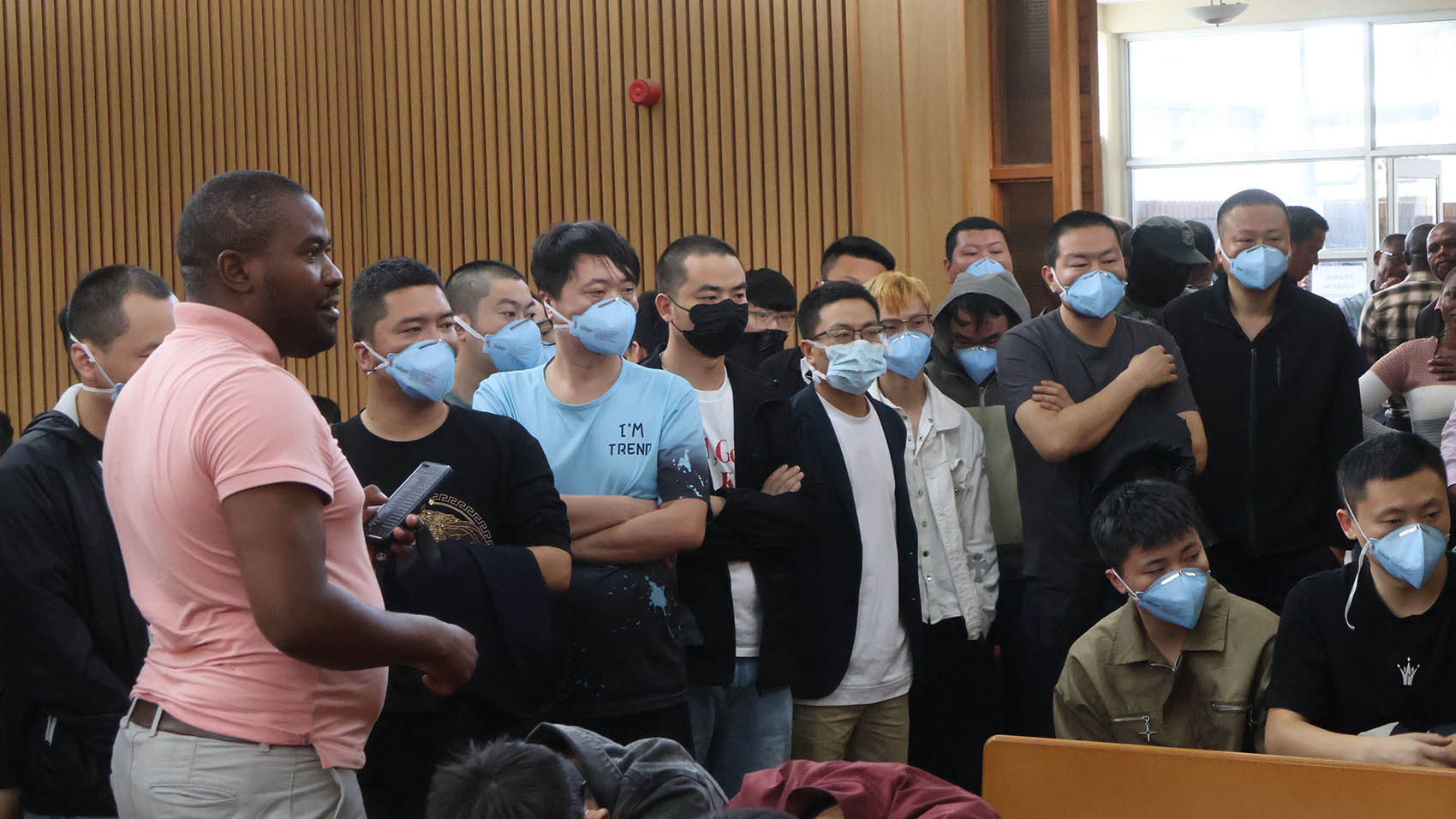 A police officer assisting some of the arrested foreign nationals to adhere to the sitting arrangement at the Mbabane Magistrates Court during a previous court appearance.